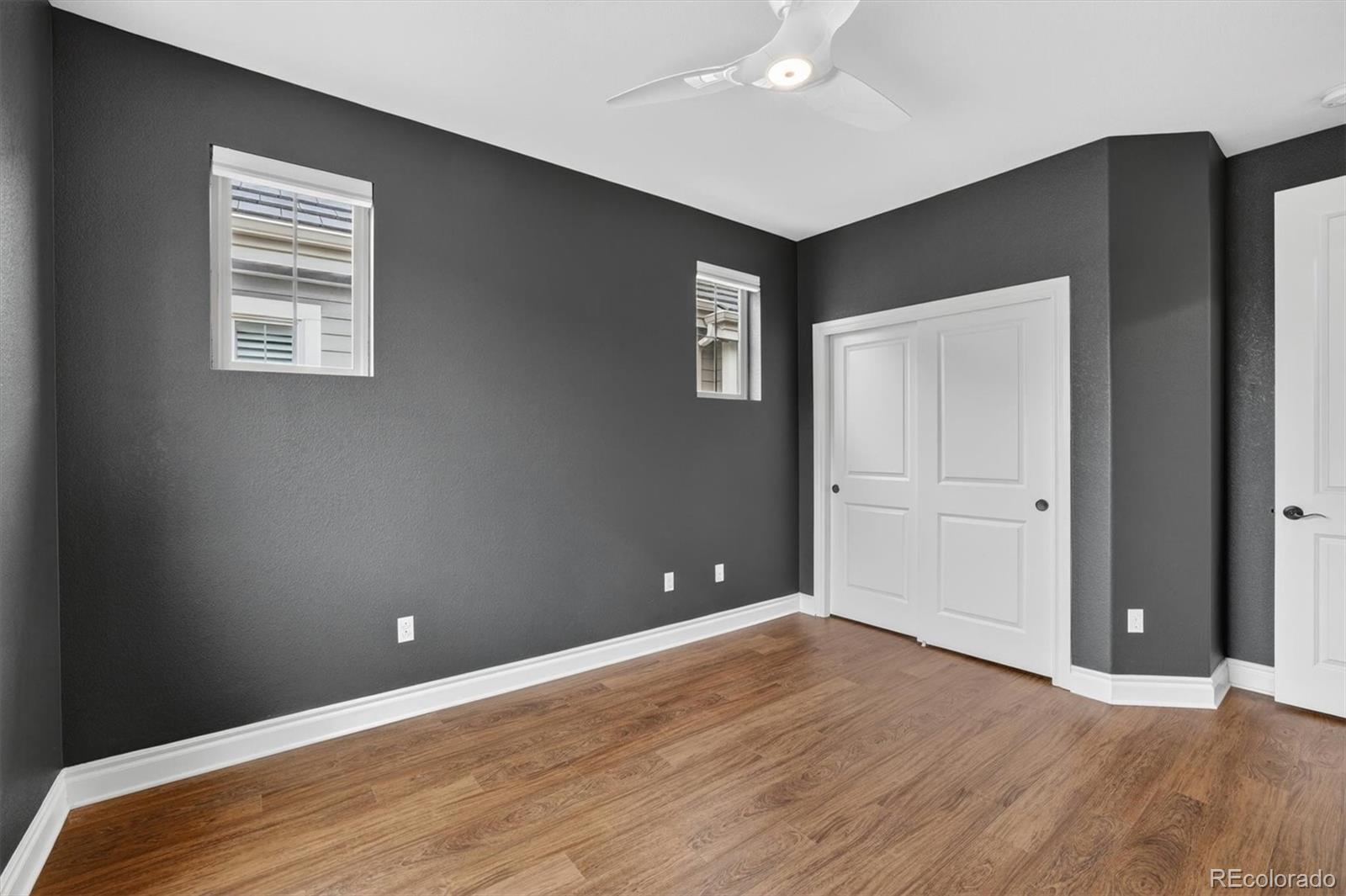 10126 RidgeGate Circle Lone Tree, CO 80124 - Photo 28 of 32 a view of an empty room with wooden floor and a window