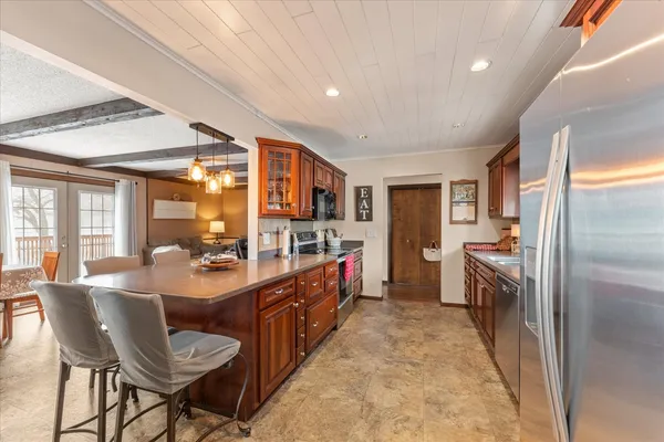 a large kitchen with a large counter top appliances and cabinets