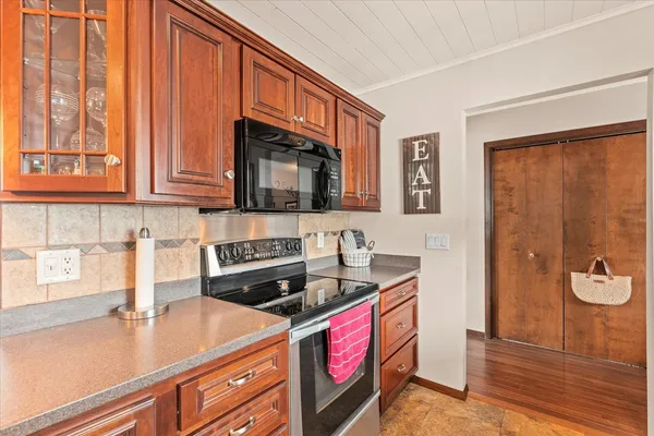 a kitchen with stainless steel appliances granite countertop a stove a sink and a microwave