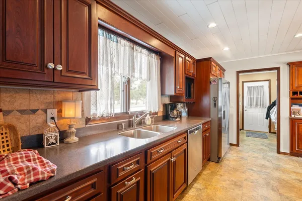 a kitchen with stainless steel appliances a sink stove and cabinets
