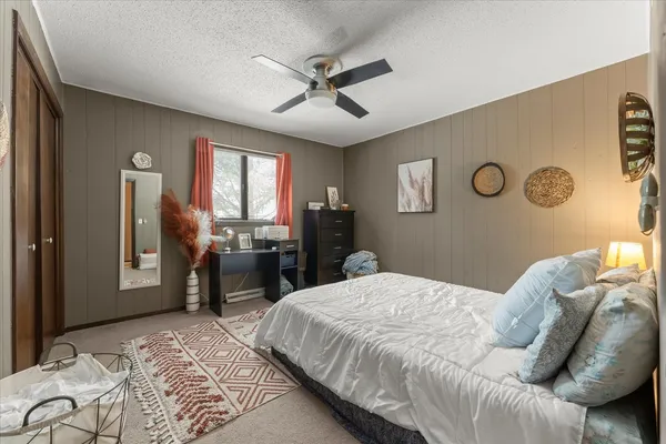 a bedroom with a bed and dresser