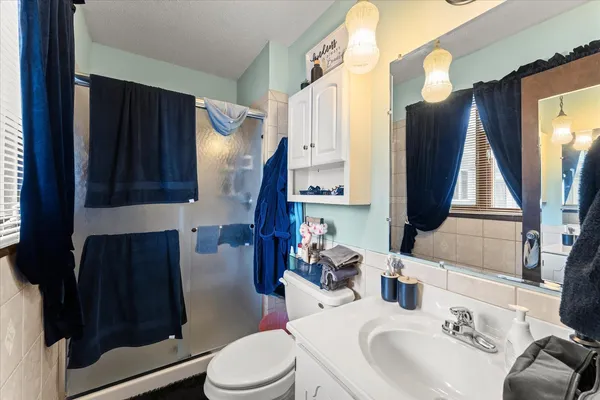 a bathroom with a sink toilet and mirror