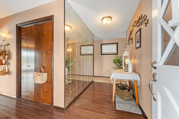 a view of an entryway door and wooden floor