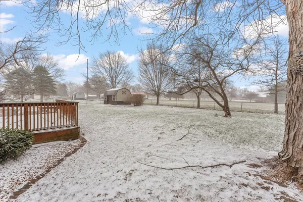a view of a back yard of the house with a patio
