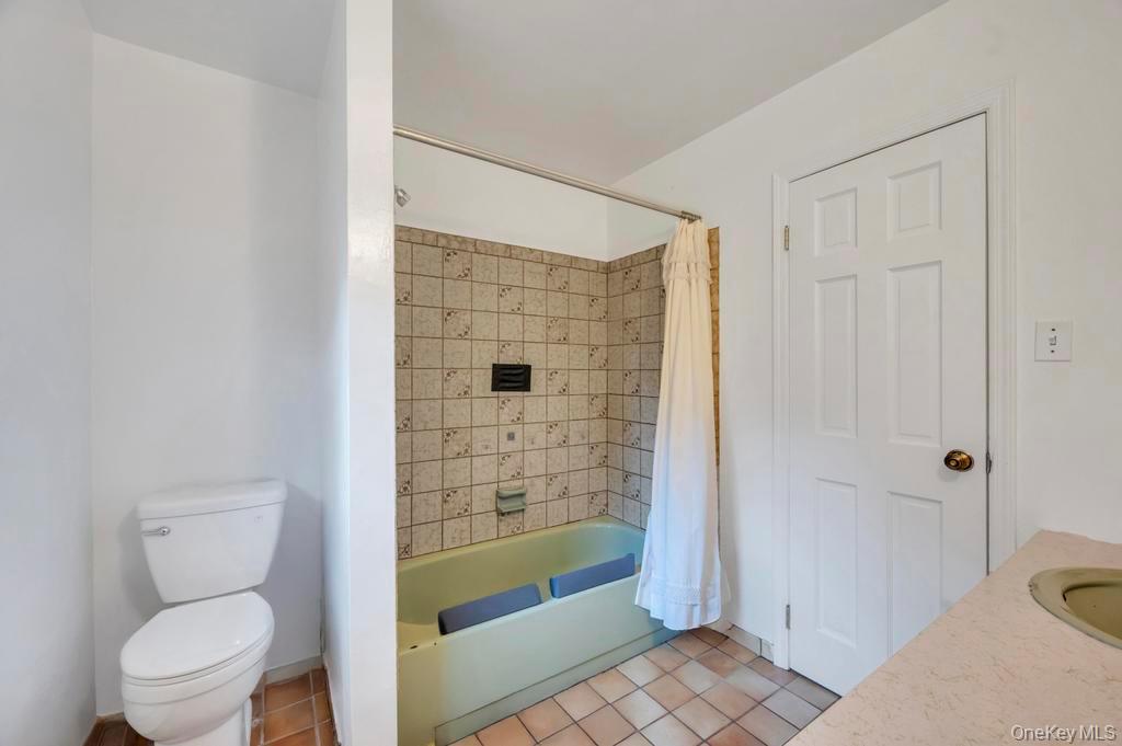 39 Bevin Road Northport, NY 11768 - Photo 28 of 44 Bathroom with vanity, light tile patterned flooring, and shower / bath combo