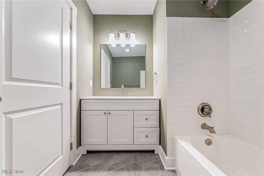 1839 Farmington Road Cleveland, OH 44112 - Photo 20 of 29 Bathroom with bathtub / shower combination, vanity, and light tile patterned flooring