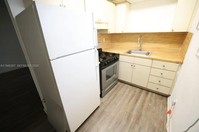 a view of a kitchen with wooden floor