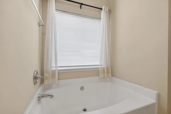 a bathroom with a tub and a shower