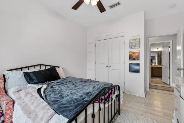 a bedroom with a bed and wooden floor