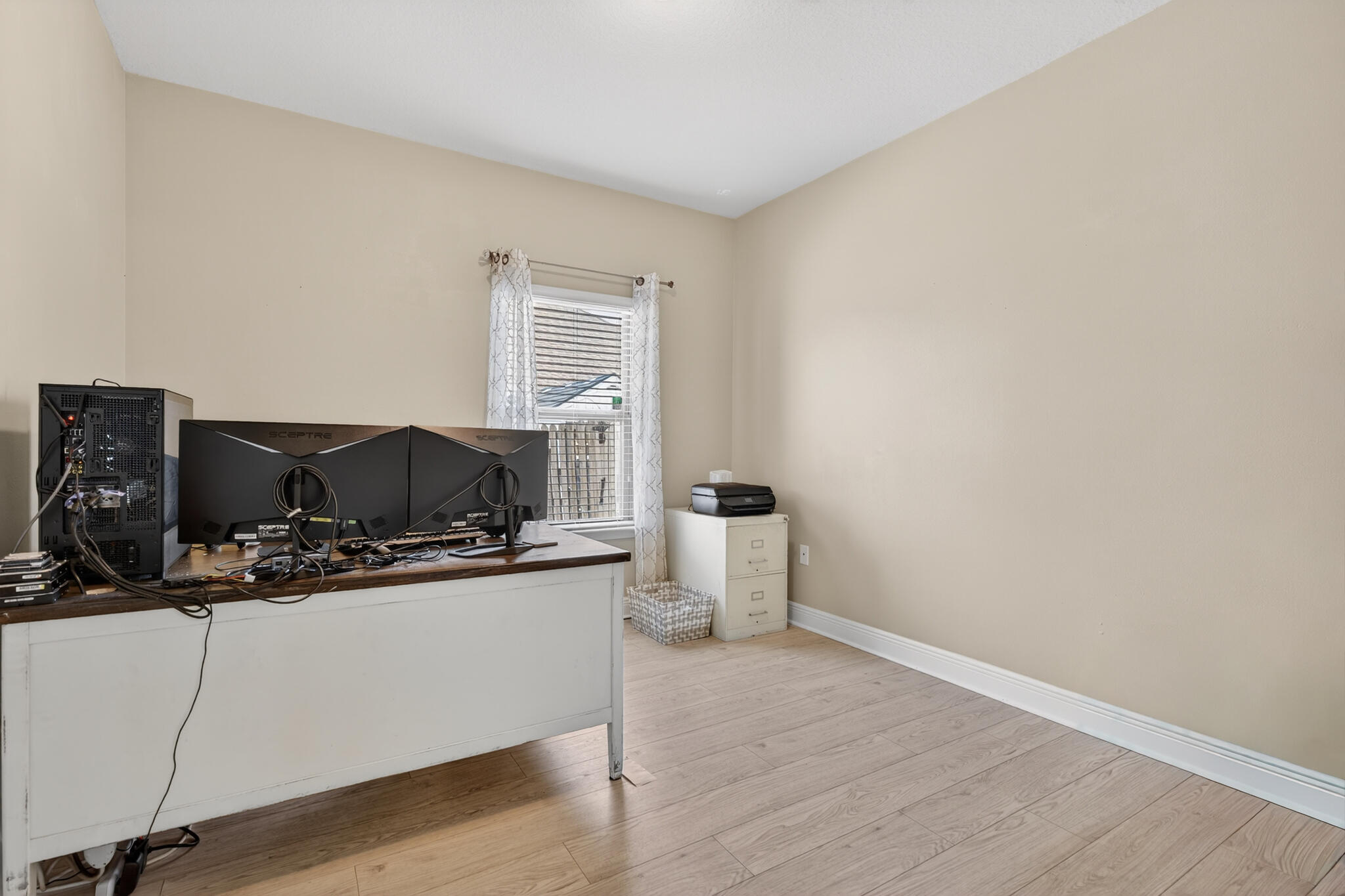 511 Gadwell Street Crestview, FL 32539 - Photo 21 of 48 a room with furniture and wooden floor