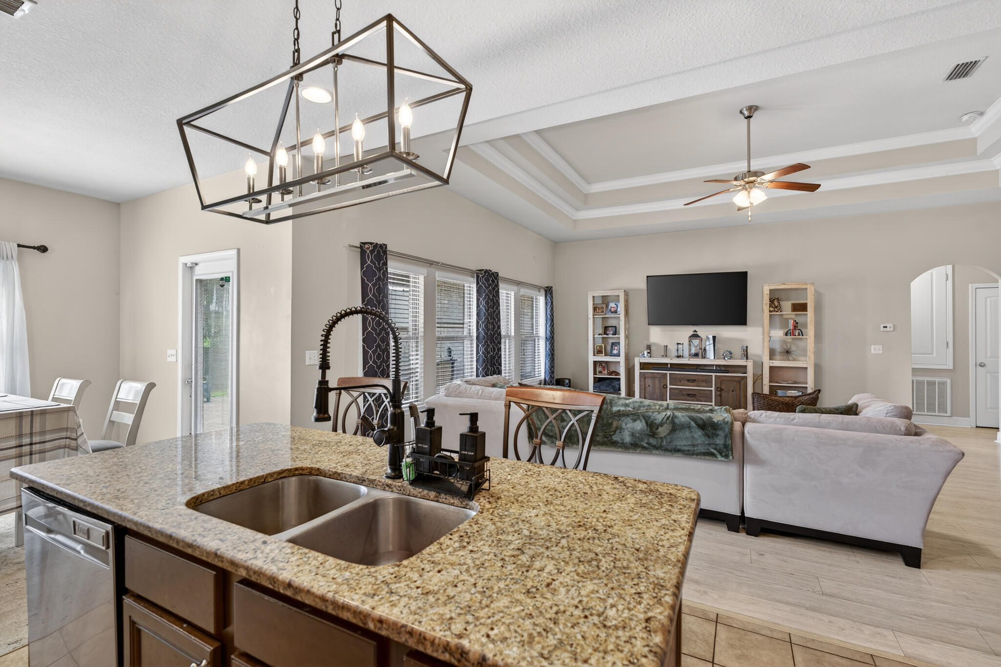 511 Gadwell Street Crestview, FL 32539 - Photo 30 of 48 a kitchen view with stainless steel appliances granite countertop a sink dishwasher a dining table and chairs with wooden floor