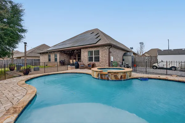 a view of a house with swimming pool yard and porch