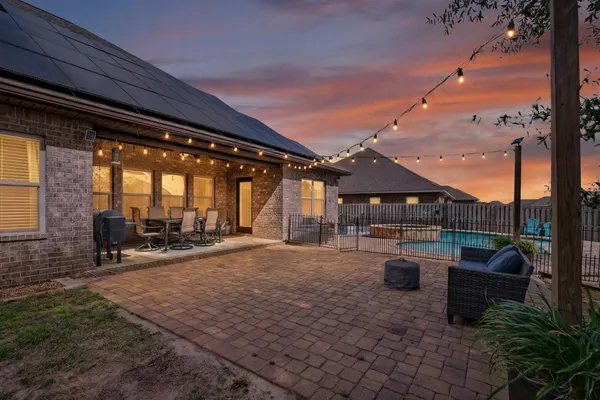 a view of a house with backyard porch and sitting area