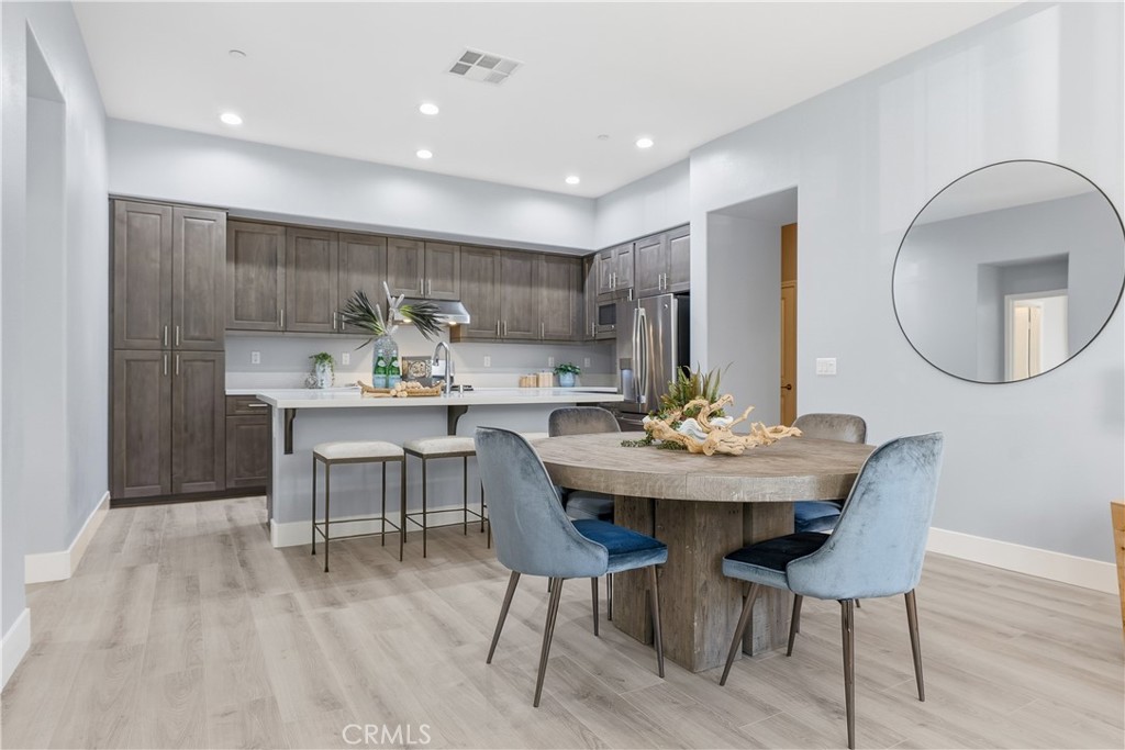 67 Promesa Avenue Rancho Mission Viejo, CA 92694 - Photo 12 of 75 a view of a dining room with furniture and wooden floor