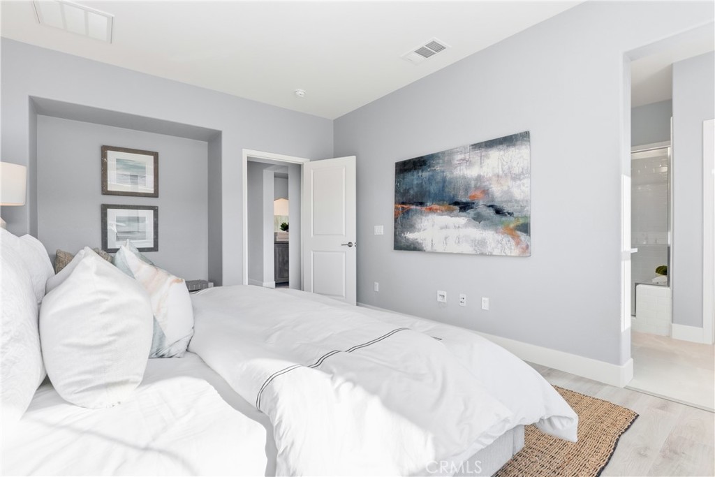 67 Promesa Avenue Rancho Mission Viejo, CA 92694 - Photo 20 of 75 a bedroom with a bed and a painting on the wall