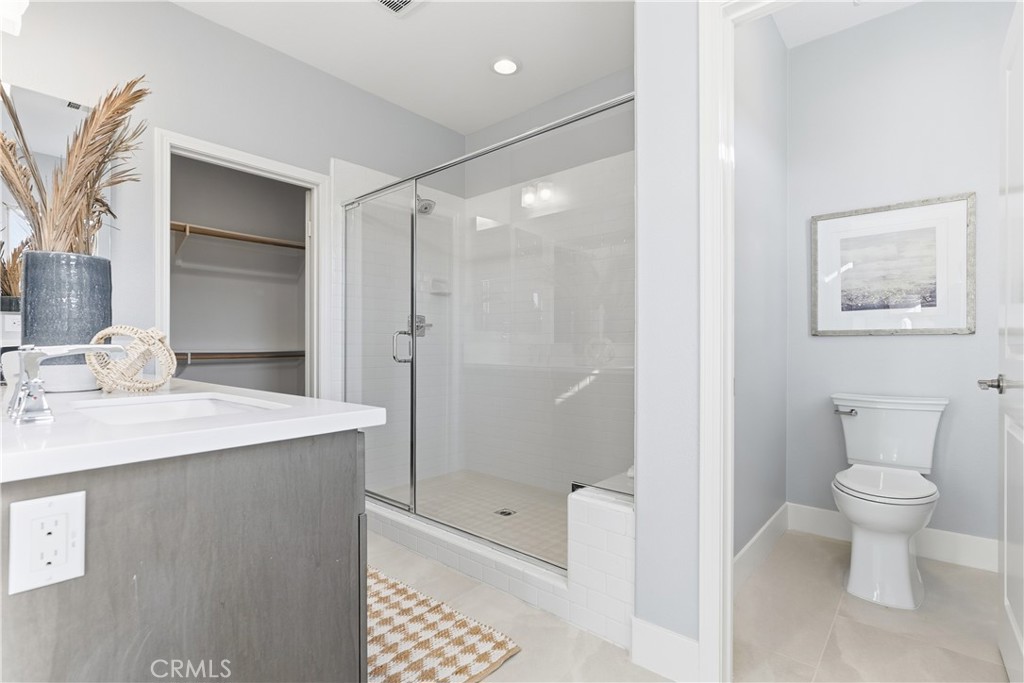 67 Promesa Avenue Rancho Mission Viejo, CA 92694 - Photo 22 of 75 a bathroom with a granite countertop sink a toilet and shower