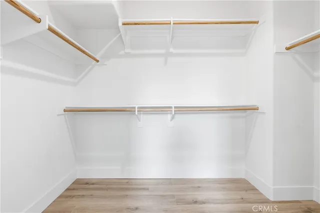 an empty room with wooden floor and sliding door