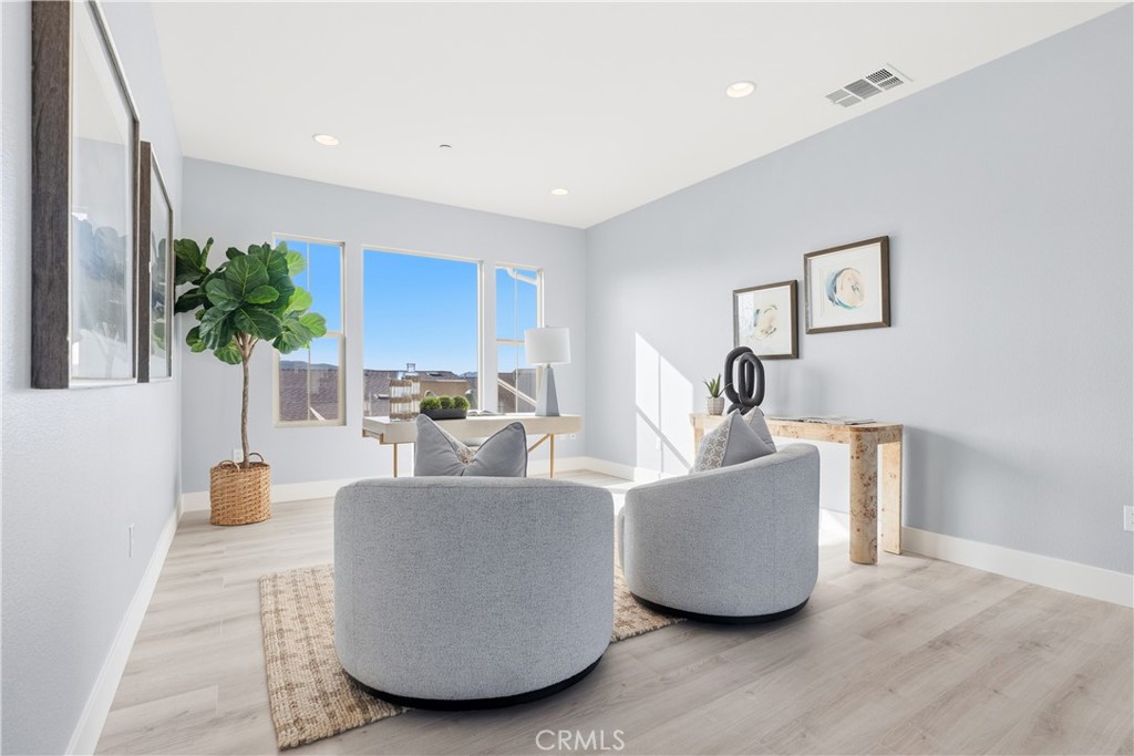 67 Promesa Avenue Rancho Mission Viejo, CA 92694 - Photo 29 of 75 a living room with furniture and a potted plant
