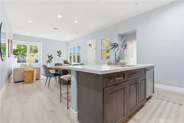 a kitchen with a sink appliances and cabinets