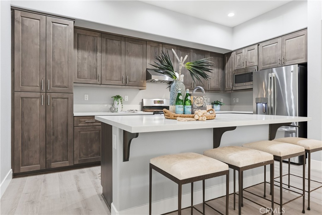 67 Promesa Avenue Rancho Mission Viejo, CA 92694 - Photo 4 of 75 a kitchen with stainless steel appliances a sink cabinets and a refrigerator