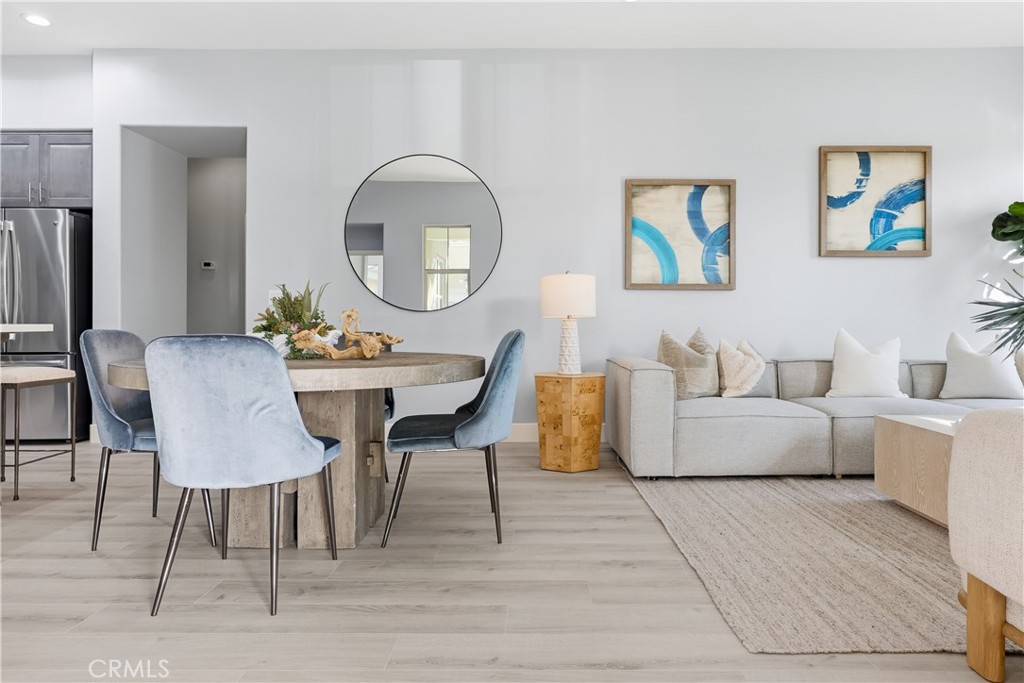 67 Promesa Avenue Rancho Mission Viejo, CA 92694 - Photo 7 of 75 a living room with furniture a large mirror and a dining table