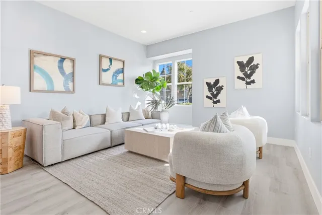 a living room with furniture and kitchen view