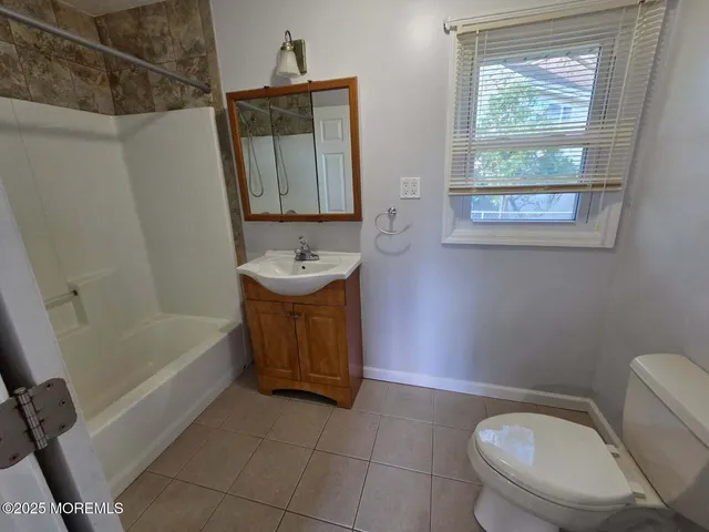 a bathroom with a sink a toilet and tub