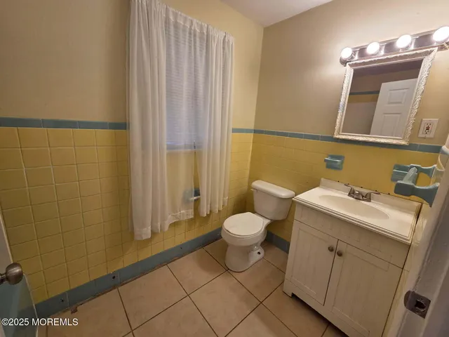 a view of a hallway with windows and stairs