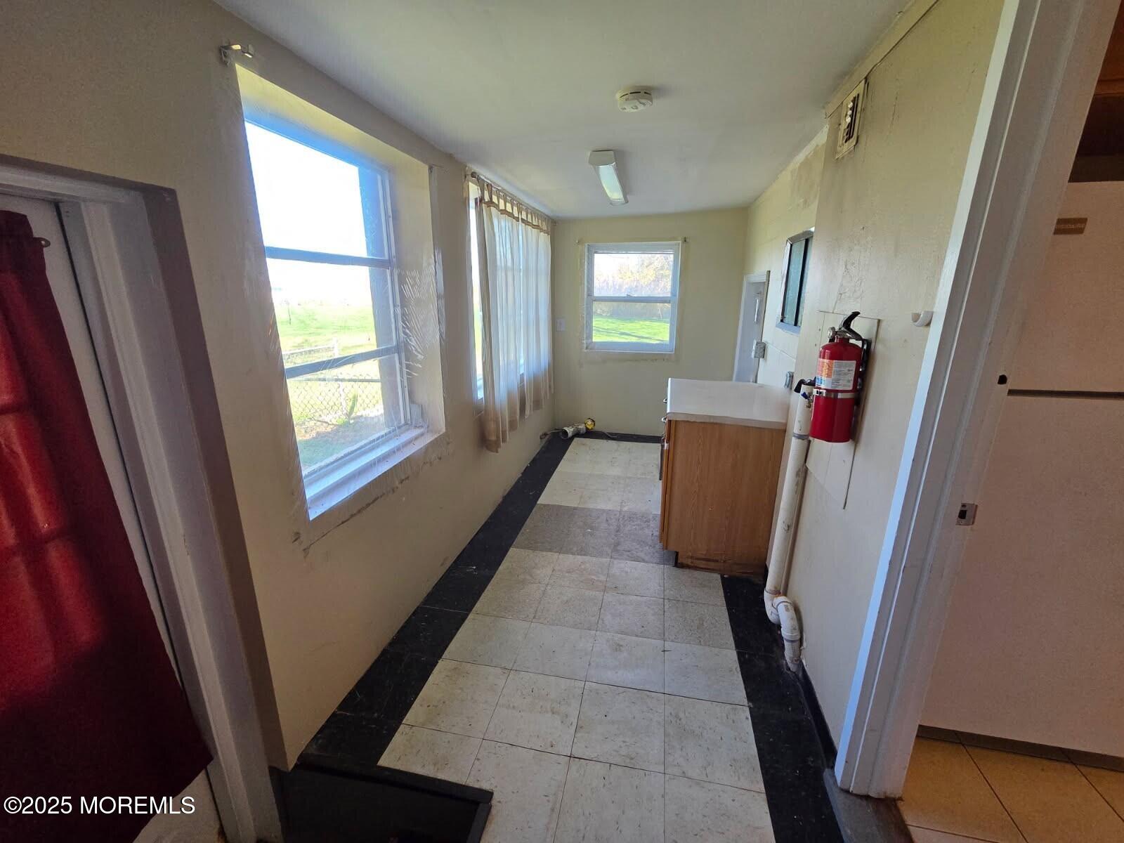 219 Dock Street Union Beach, NJ 07735 - Photo 19 of 22 a view of a hallway with windows and stairs
