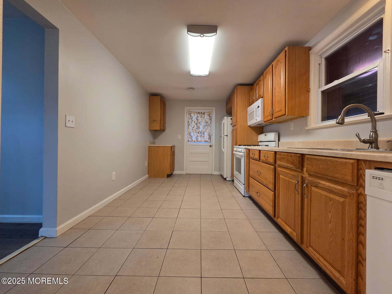 219 Dock Street Union Beach, NJ 07735 - Photo 22 of 22 a view of a kitchen with a sink and a refrigerator