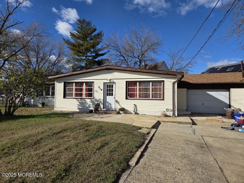219 Dock Street Union Beach, NJ 07735 - Photo 4 of 22 a front view of a house with yard outdoor seating and barbeque oven