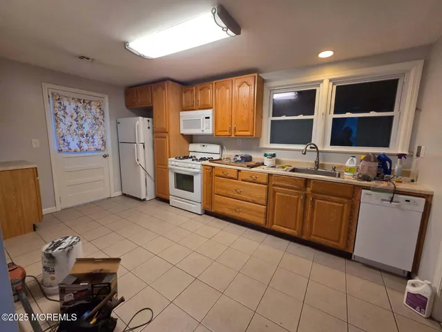 a kitchen with a sink appliances and cabinets