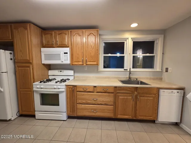 a kitchen with stainless steel appliances a sink stove and cabinets