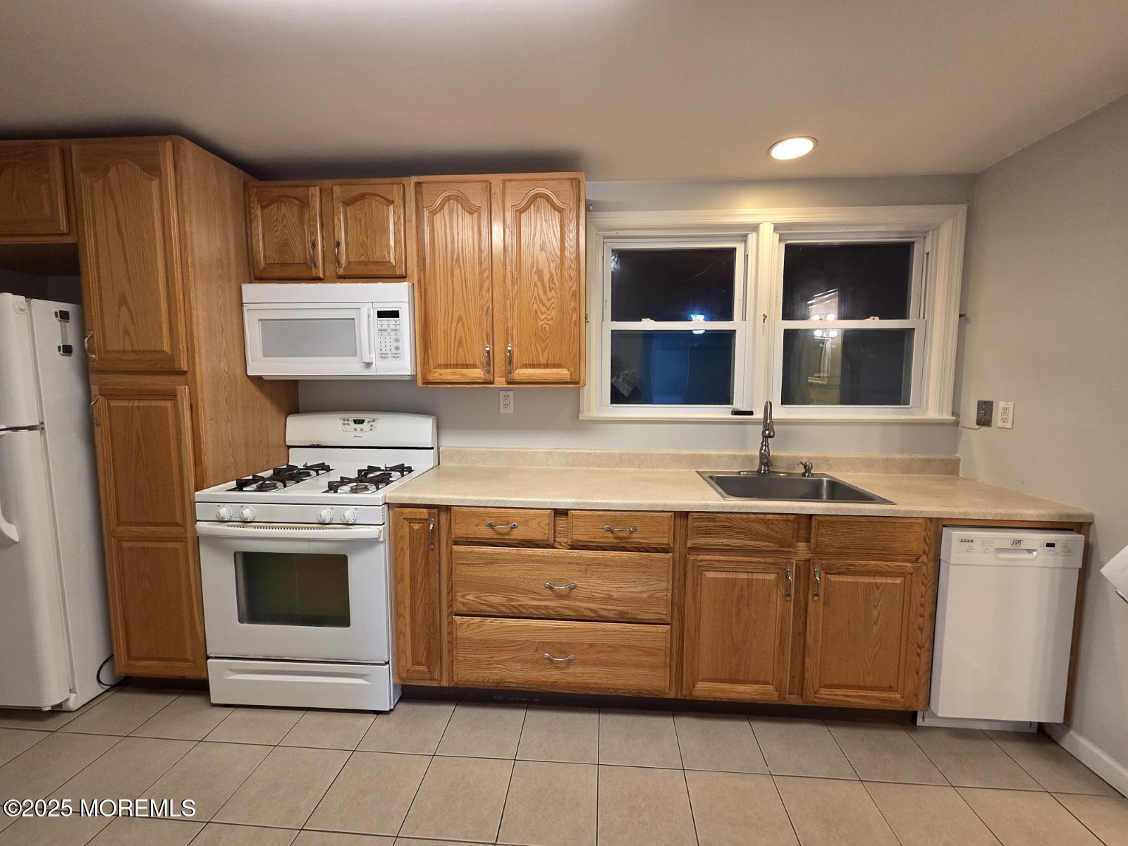 219 Dock Street Union Beach, NJ 07735 - Photo 7 of 22 a kitchen with stainless steel appliances granite countertop a stove and a refrigerator