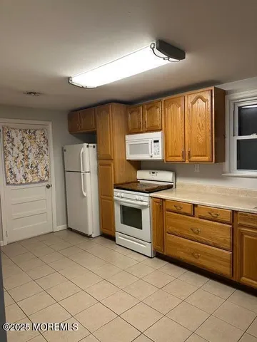 a kitchen with stainless steel appliances a stove sink and cabinets