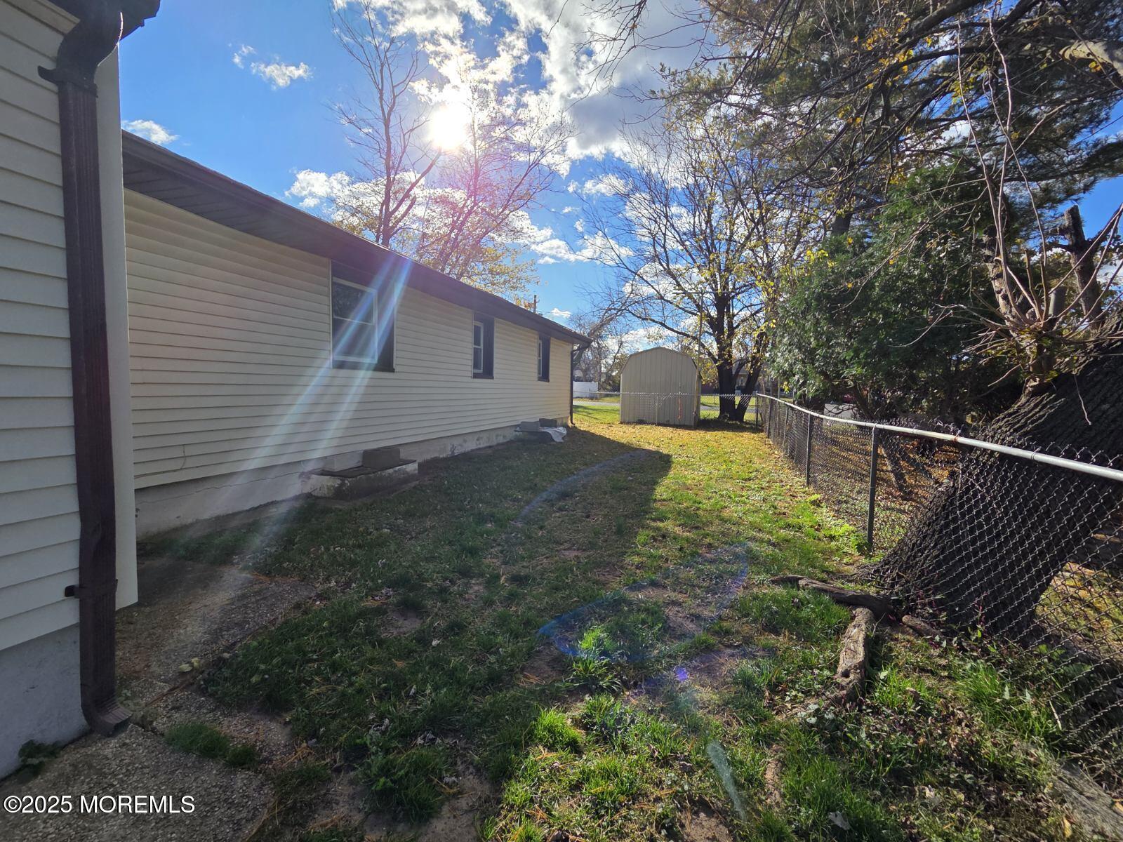 219 Dock Street Union Beach, NJ 07735 - Photo 10 of 22 a view of a yard with wooden fence and large tree