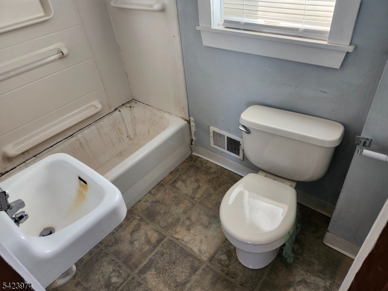 5 Locust Street Wanaque, NJ 07420 - Photo 11 of 23 a white toilet sitting next to a bath tub