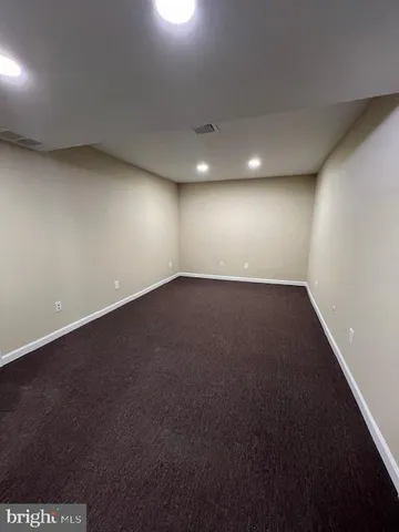 an empty room with a empty space and windows