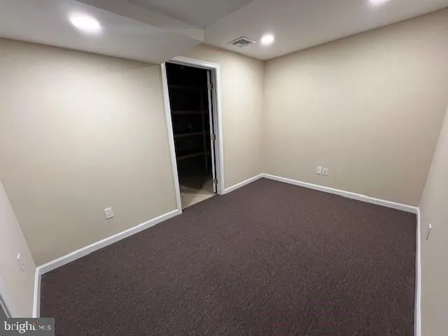 an empty room with closet area