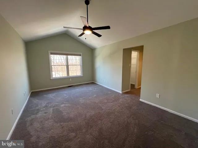 a view of a livingroom with a ceiling fan and window