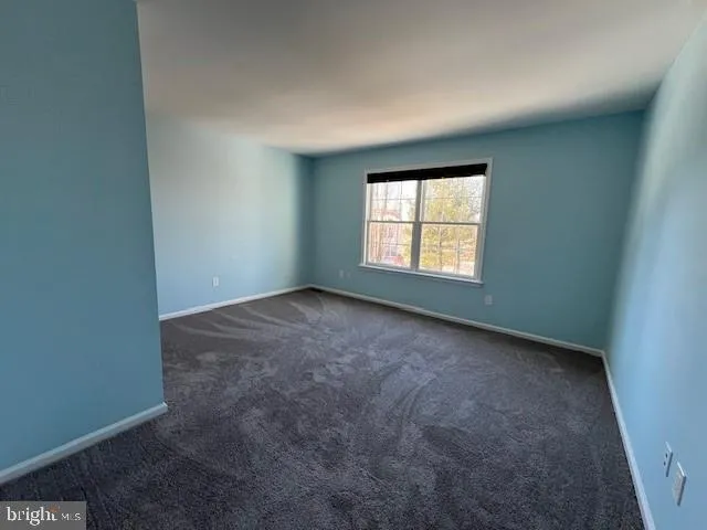 a spacious bathroom with a toilet sink and mirror