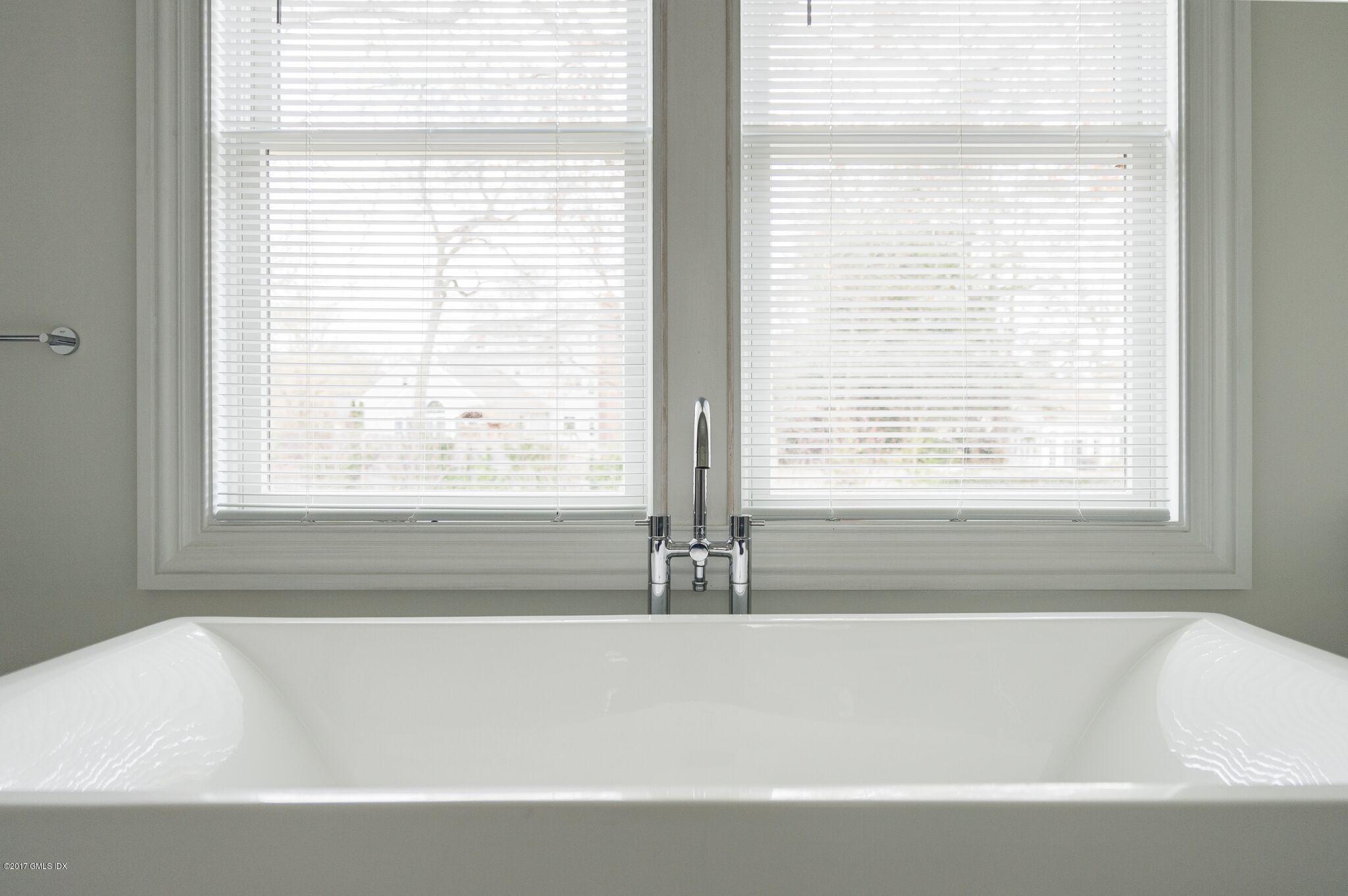 69 Circle Drive Greenwich, CT 06830 - Photo 12 of 21 a white bath tub sitting next to a window