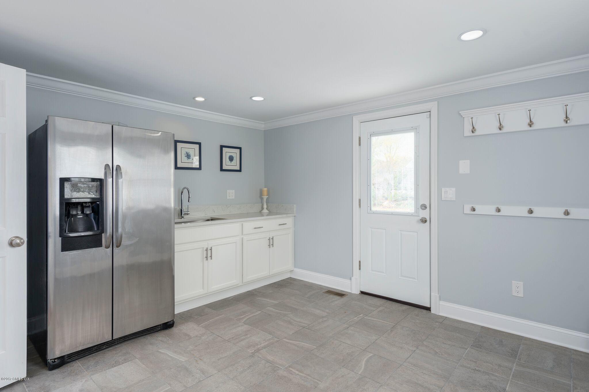 69 Circle Drive Greenwich, CT 06830 - Photo 15 of 21 a kitchen with granite countertop stainless steel appliances and refrigerator