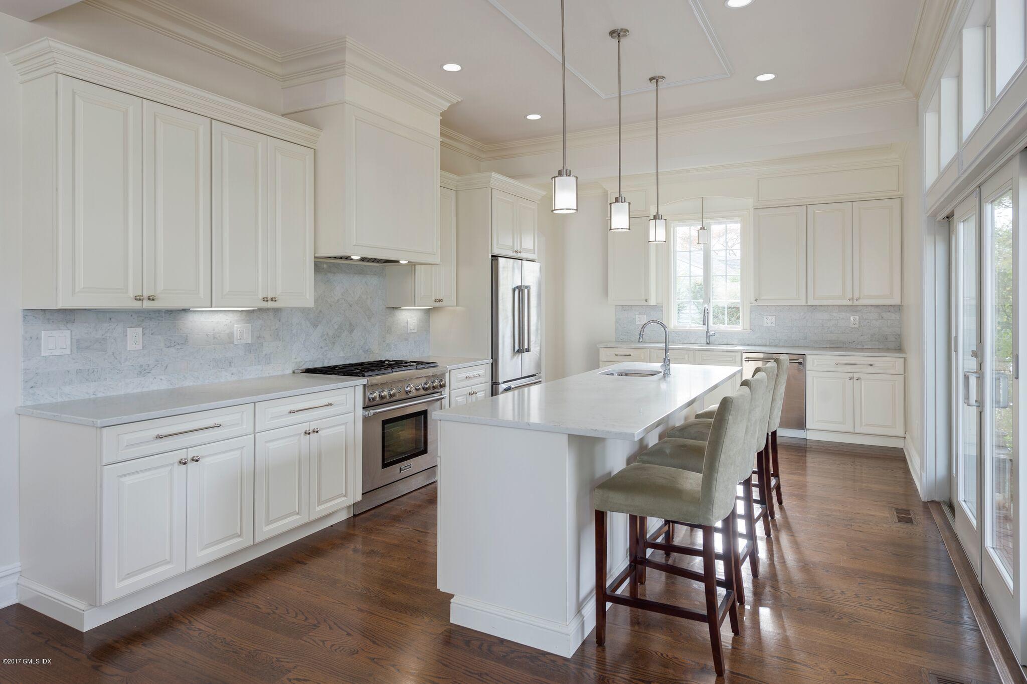 69 Circle Drive Greenwich, CT 06830 - Photo 2 of 21 a kitchen with stainless steel appliances kitchen island granite countertop a kitchen island a hardwood floor and a sink