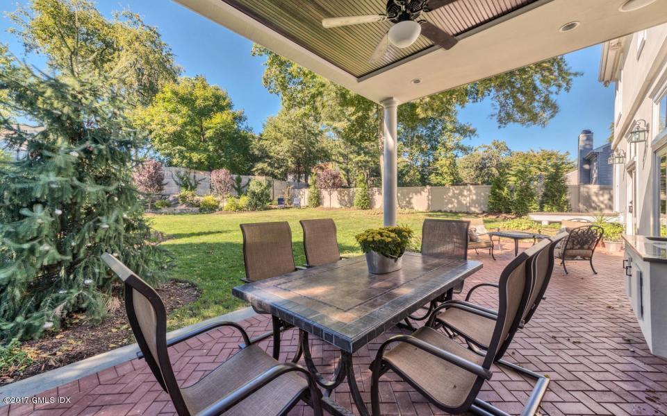 69 Circle Drive Greenwich, CT 06830 - Photo 4 of 21 a view of a patio with table and chairs and potted plants