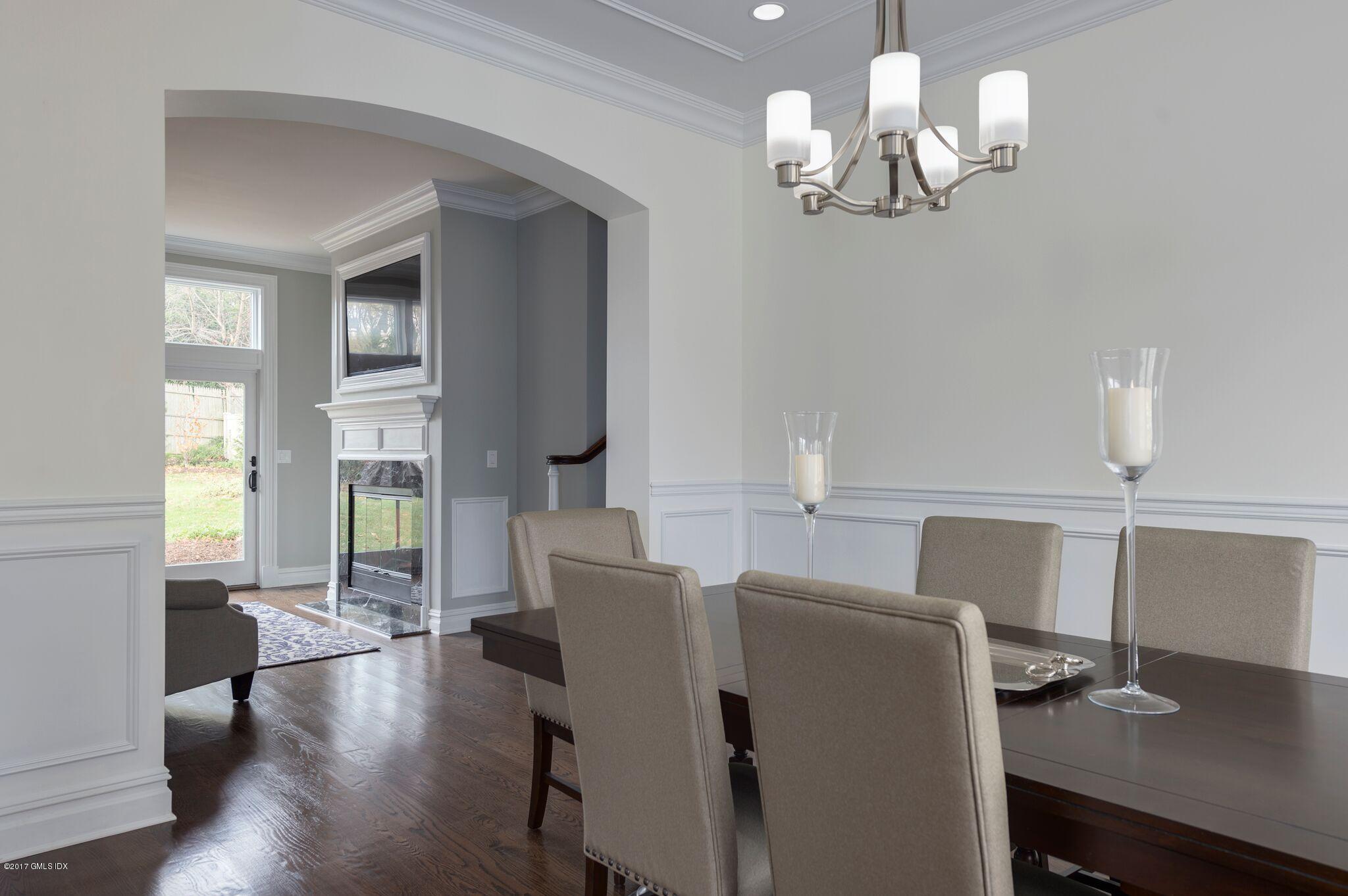 69 Circle Drive Greenwich, CT 06830 - Photo 6 of 21 a view of a dining room with furniture a chandelier and wooden floor