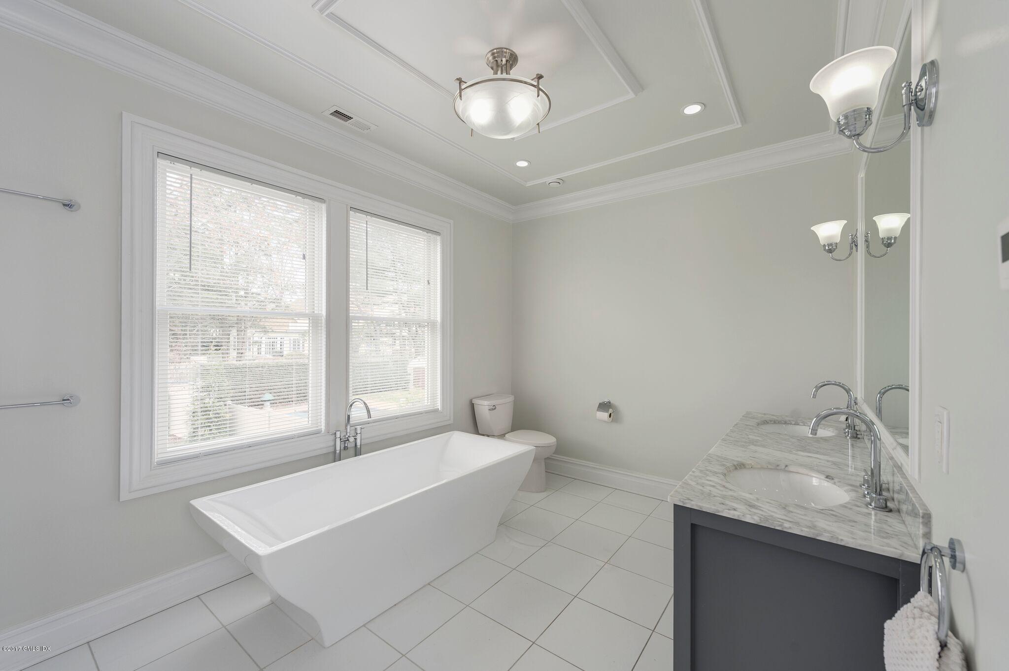 69 Circle Drive Greenwich, CT 06830 - Photo 10 of 21 a spacious bathroom with a granite countertop sink a toilet and a bathtub