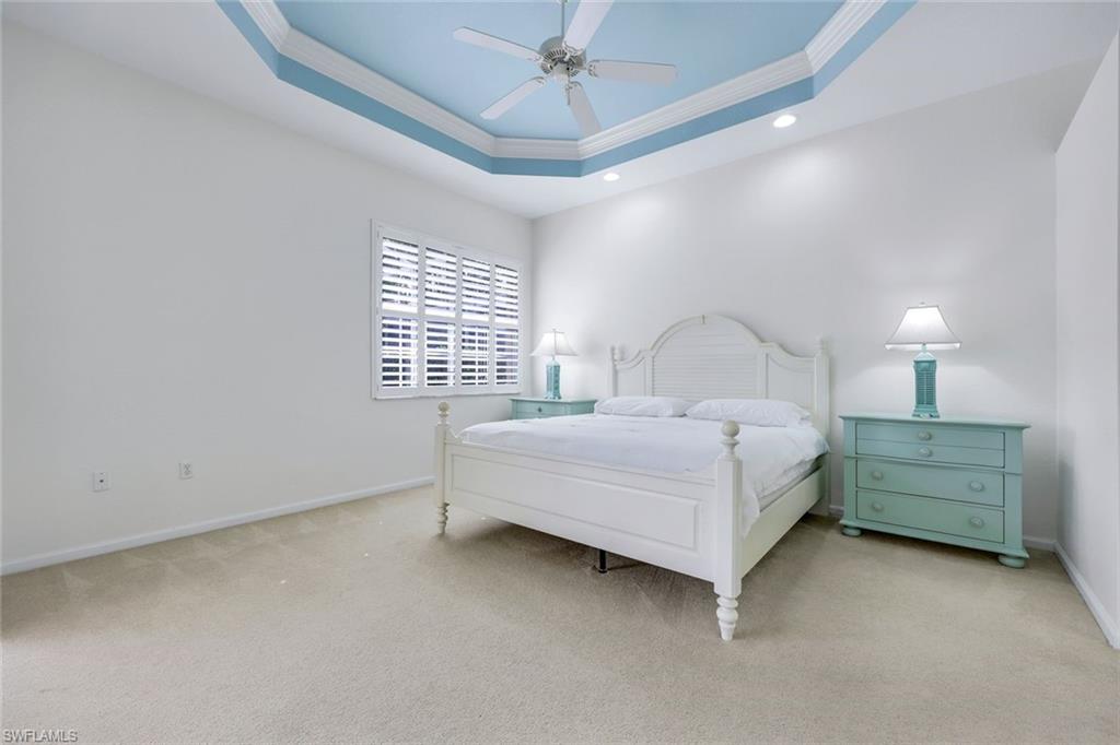 9375 Oak Strand Drive Estero, FL 34135 - Photo 13 of 30 a bedroom with a bed chandelier and a window