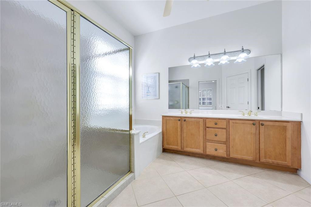 9375 Oak Strand Drive Estero, FL 34135 - Photo 15 of 30 a spacious bathroom with a granite countertop sink mirror and bathtub