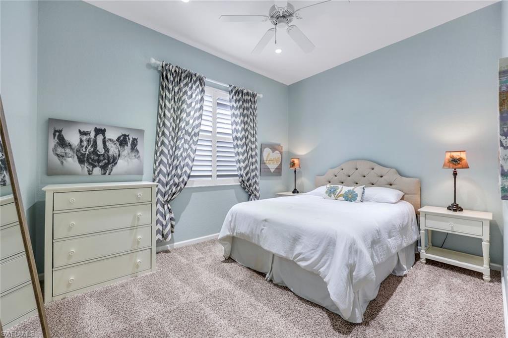 9375 Oak Strand Drive Estero, FL 34135 - Photo 17 of 30 a bedroom with a bed and a cabinets
